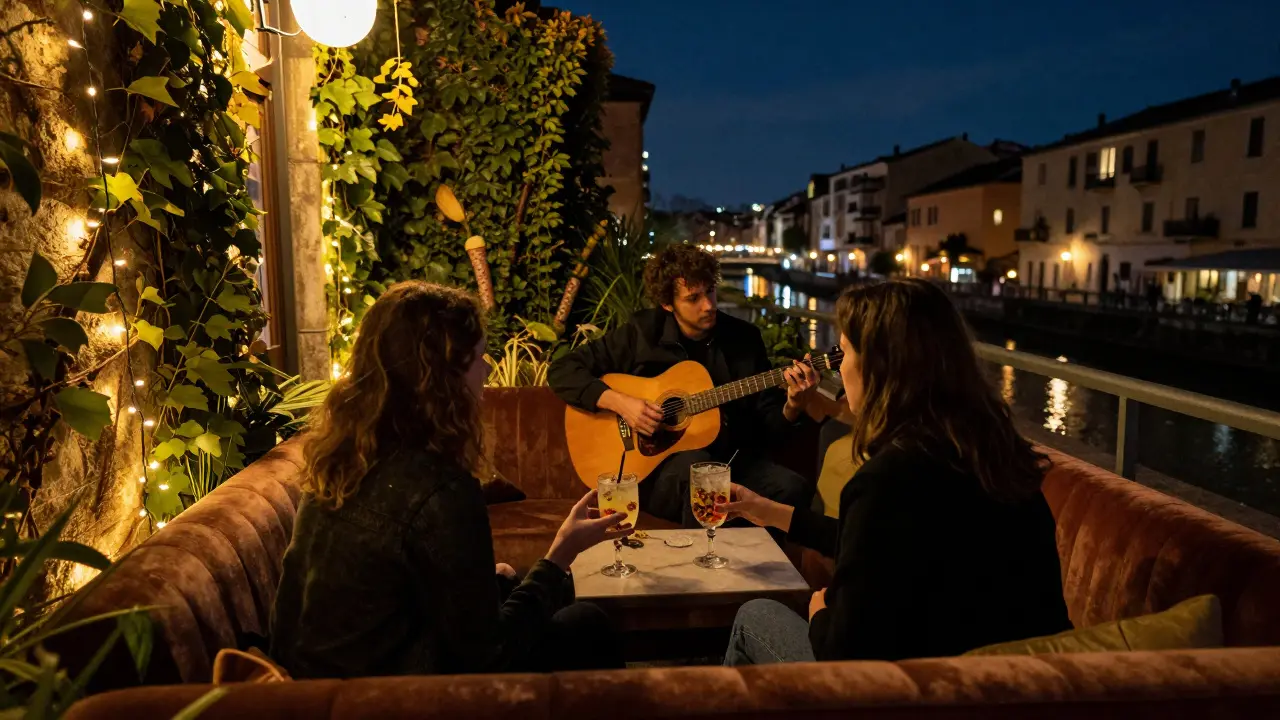 Le Jardin rooftop lounge at night, couples on velvet couches under string lights with Milan's canal skyline behind.