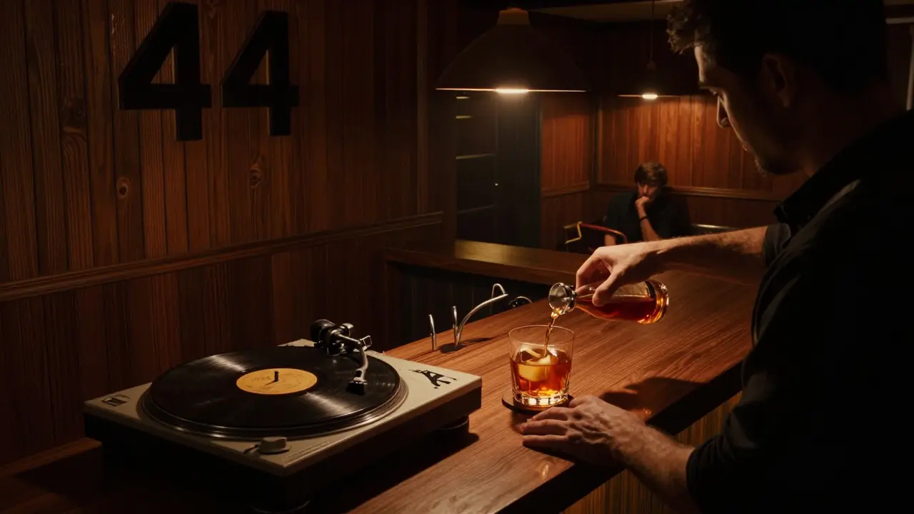 Hidden bar with dark wood interior, vinyl records, and bartender pouring a date syrup cocktail.